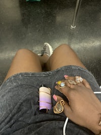 a woman sitting on a train with a cell phone in her hand